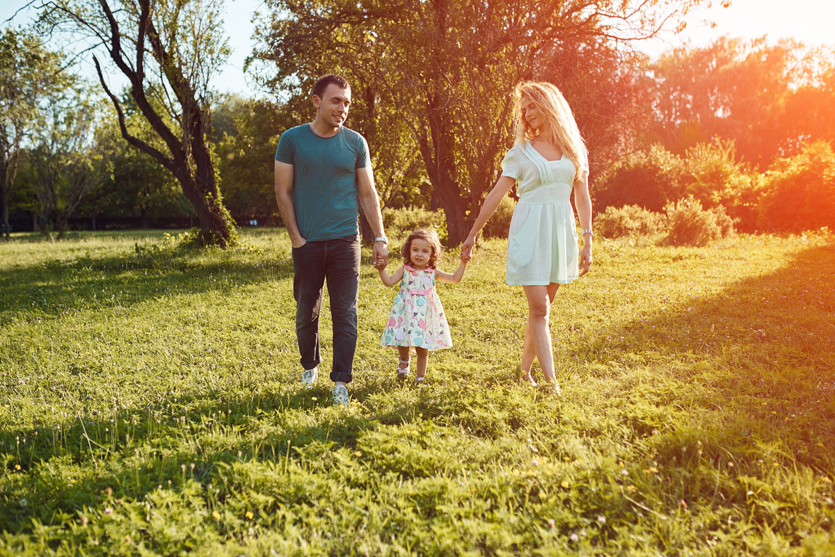 happy-young-family-spending-time-together-outside