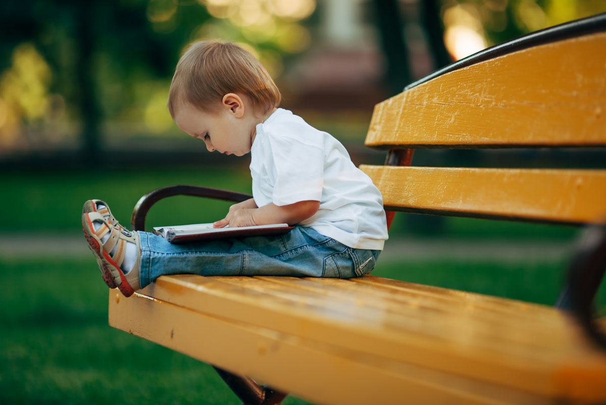 little-reading-boy-in-summer-park